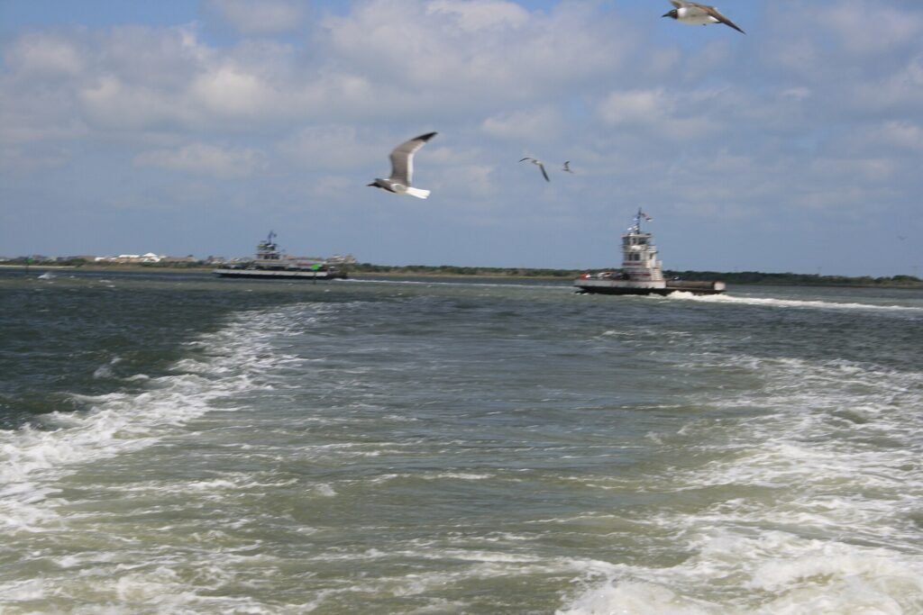 Two ferries passing each other mid-crossing in Hatteras Inlet