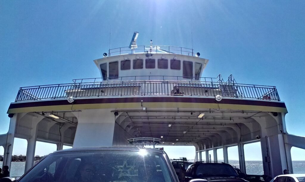 Looking up at the white upper decks of a North Carolina ferry from the car deck